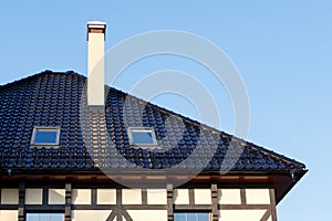 Roof of black glazed ceramic tiles with Dormer Windows and ventilation pipe