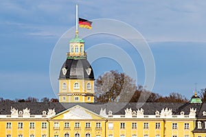 Roof of Castle Karlsruhe, with German Flag at Halfmast, auf Halbmast, on the tower roof in winter. In Baden-WÃ¼rttemberg, Germany