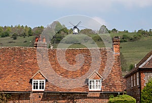 Roof of characterful cottage in the village of Turville in the Chilterns, with Cobstone Mill at the top of the hill behind.