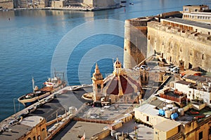 Roof of church of Our Lady of Liesse in Valletta, Malta. Panoramic skyline view of ancient defences of Valletta, Tree