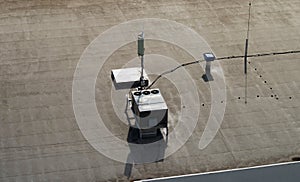 Roof of a commercial building with a external units of the commercial air conditioning and ventilation systems, cellular antenna a