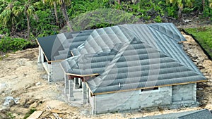 Roof construction on newly built house. Building rooftop covered with underlayment felt layer ready for installation of