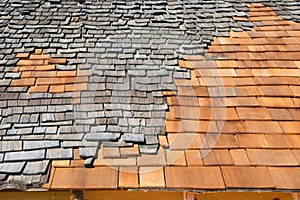 Roof construction site. Removal of old roof, replacement with new shingles, equipment and repair