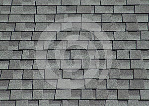 The roof is covered with soft tiles in the form of geometric plates