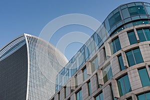 Roof and facade of two buildings , blue sky on background.