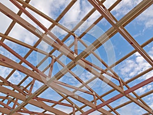 Roof frame construction under cloudy blue sky