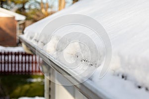 Roof gutter full of snow and ice after winter storm