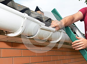 Roof gutter repair. Guttering repair. Roofer contractor  repair rain gutter