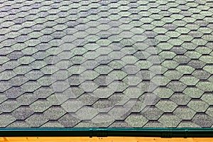 The roof of the house is covered with soft tiles, bitumen shingles