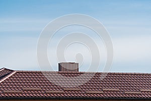 The roof of the house is made of red metal tiles. Concept installing house roof. Modern new house