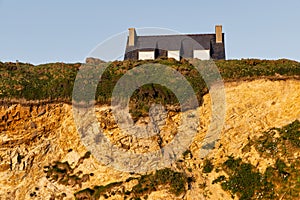 roof of a house over a cliff at the coast of the Crozon peninsula, France