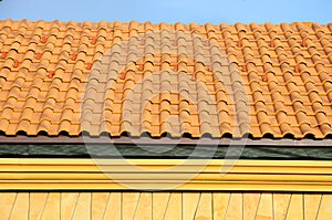 Roof house with tiled roof on blue sky. detail of the tiles and corner mounting on a roof, horizontal.