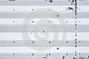 Roof of industrial building. construction workers installing ventilation equipment on warehouse roof. aerial top view