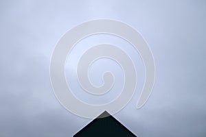 Roof of industrial warehouse against gray sky