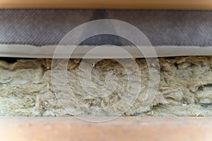 Roof insulation with mineral wool, close-up. Mineral wool between cladding and roof