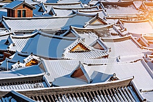 Roof of Jeonju traditional Korean village covered with snow, Jeonju Hanok village in winter, Korea.