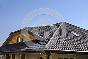 Roof made of metal roof tiles. Interestingly solved roof surface