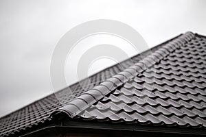 Roof made of metal tiles close-up. Banner texture for roofers