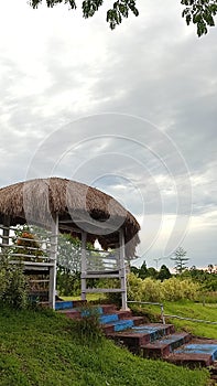 the roof of the monument which resembles a honai is made of piles of straw leaves and some use sago leaves