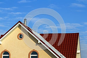 Roof of a new built house with nice window and chimney.