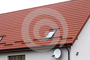 Roof of a new house made from red roofing tiles