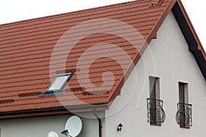 Roof of a new house made from yellow roofing tiles