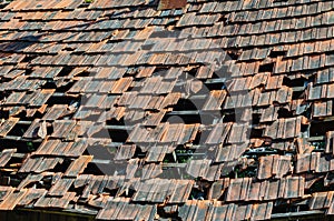 Roof of an old abandoned house with broken and fallen tiles