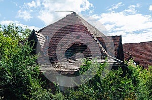 Roof of an old abandoned house with broken and fallen tiles