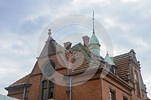 Roof of old building with pin and round window in Zelenogradsk. German architecture of last century