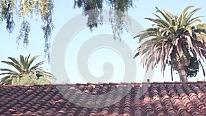 Roof of old mexican house tiled, ceramic clay tiles. Suburban California garden.