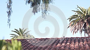Roof of old mexican house tiled, ceramic clay tiles. Suburban California garden.
