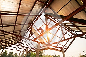 Roof repair, Construction worker installing new roof, roofing tools, power drill used on new roof with sheet metal. Roofing -