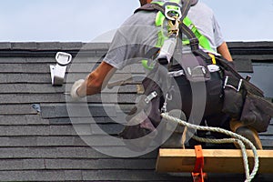 Roof repair construction worker roofer man roofing security rope