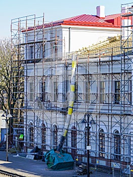 Roof repair of a historic building, restoration and painting of the facade