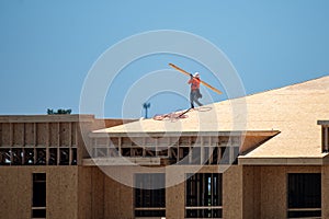 Roof repair on rooftop. Builder roofer install new roof. Construction worker roofing on a large roof apartment building
