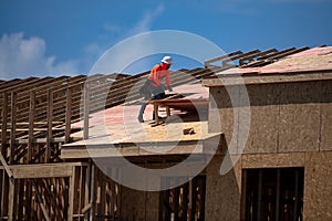 Roof repair on rooftop. Construction worker install new roof. Construction worker roofing on a large roof apartment