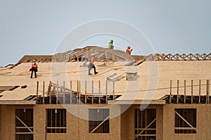 Roof repair on rooftop. Construction worker install new roof. Construction worker roofing on a large roof apartment