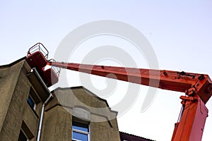 Roof repair. Truck-mounted crane at renovation work on the roof