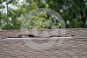Roof shingles have been damaged by high winds and strong storms