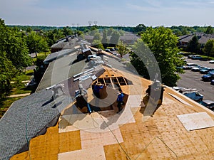 Roof shingles need with new shingles of an apartment building replacing gray asphalt tile photo