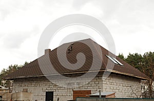 Roof Shingles - Roofing. Asphalt Roofing Shingles. Urban house or building. Bitumen tile roof. Unfinished chimney system