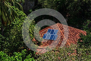 Roof with solar panels fragment in the forest