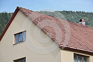 The roof of this square ceramic tile is red. The old type of roof covering in rich houses of the 19th century