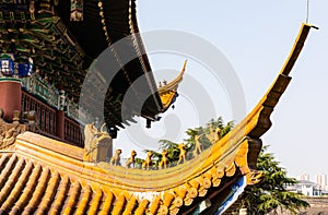 Roof statuettes of ceramic charms or walking beasts along ridge line of Mahavira or Main Hall in historic Buddhist Jinshan Temple