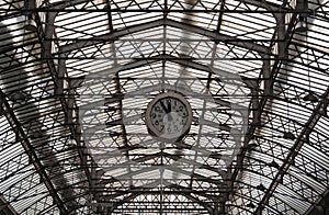 Roof structure of the Paris railway station Gare de l`Est with clock