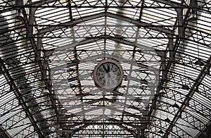 Roof structure of the Paris railway station Gare de l`Est with clock photo