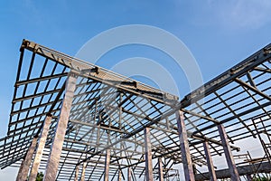 Roof structure of steel for building or house under construction on sky background