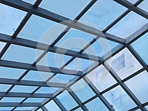 Roof structures made of metal and blue glass overhead