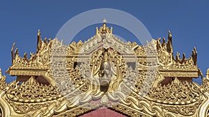 The roof of the temple is painted in gold and decorated with elegant carved ornaments