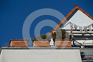 Roof terrace with terracotta flower box behind is the gable